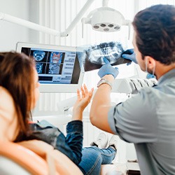 Dentist and patient looking at X-ray together