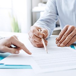 Two people reviewing insurance paperwork