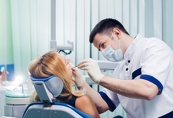 Dentist examining woman’s mouth