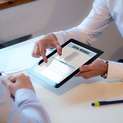 An insurance agent presenting a dental insurance form to a patient