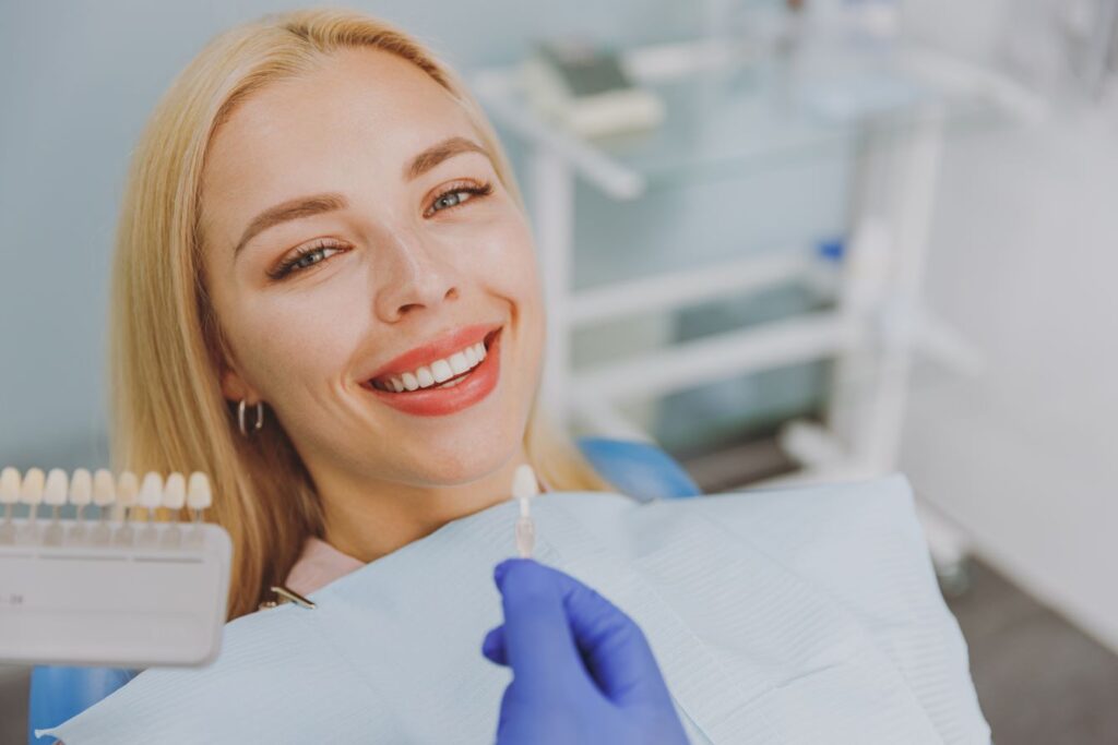 A woman smiling in a dentists chair